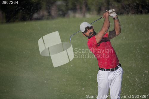 Image of golfer hitting a sand bunker shot