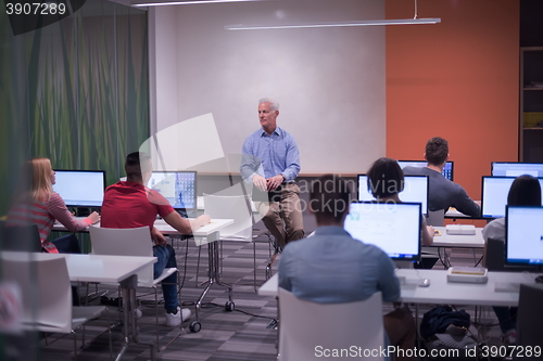 Image of teacher and students in computer lab classroom