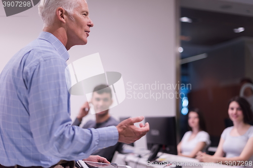 Image of teacher and students in computer lab classroom