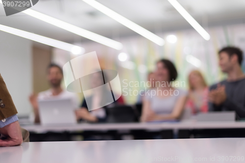 Image of teacher with a group of students in classroom