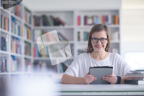 Image of student with tablet in library