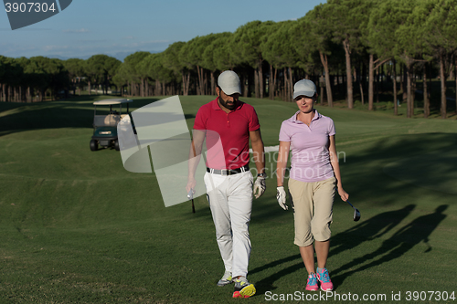 Image of couple walking on golf course