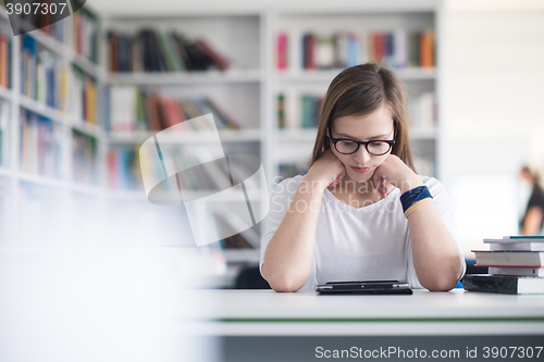 Image of student with tablet in library