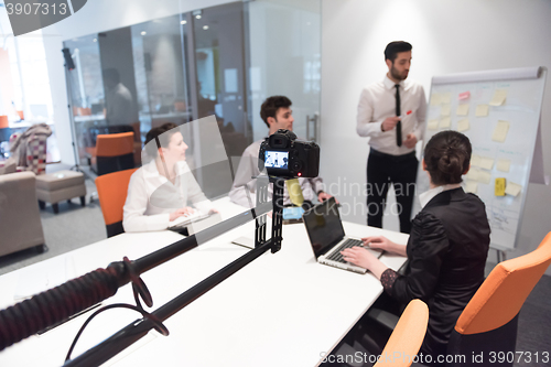 Image of business people group brainstorming and taking notes to flip boa