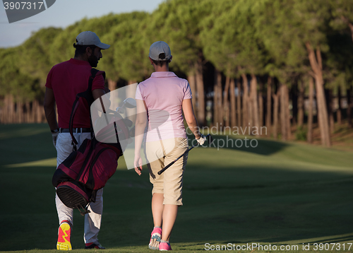 Image of couple walking on golf course