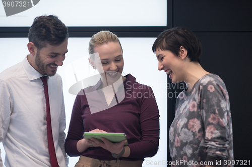 Image of young business people group working on tablet