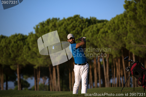 Image of golfer hitting a sand bunker shot on sunset