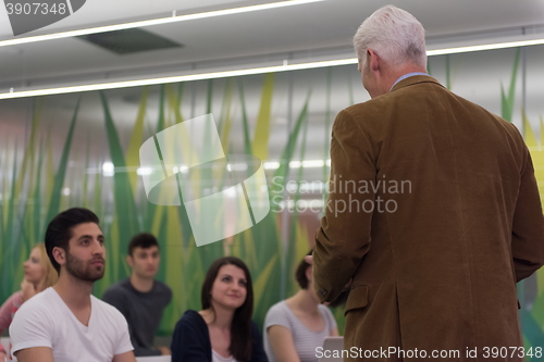 Image of teacher with a group of students in classroom