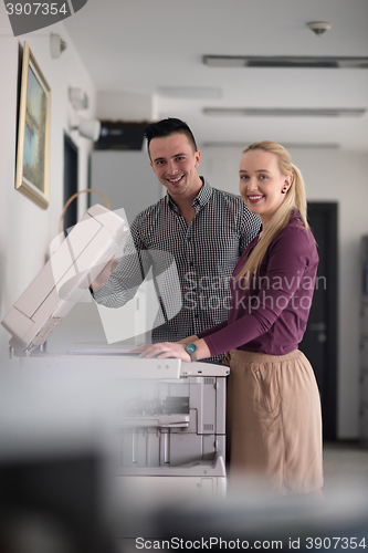 Image of business couple copy documents