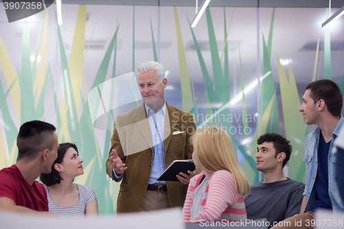 Image of teacher with a group of students in classroom