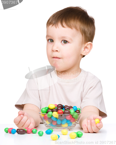 Image of Portrait of a boy with candies