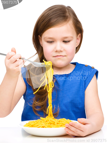 Image of Little girl is eating spaghetti