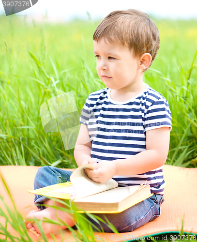 Image of Little boy is reading book