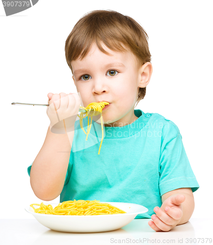 Image of Little boy is eating spaghetti