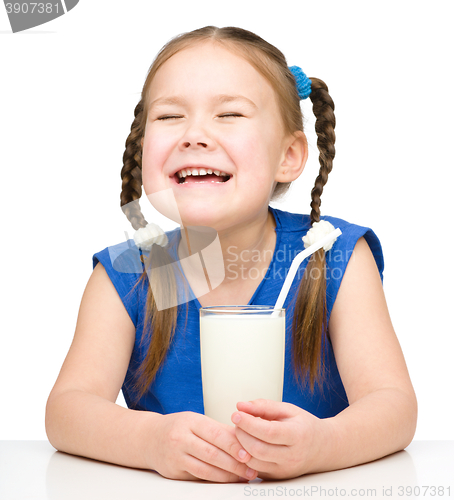 Image of Sad little girl with a glass of milk