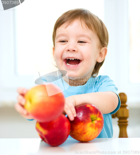 Image of Portrait of a happy little boy with apples
