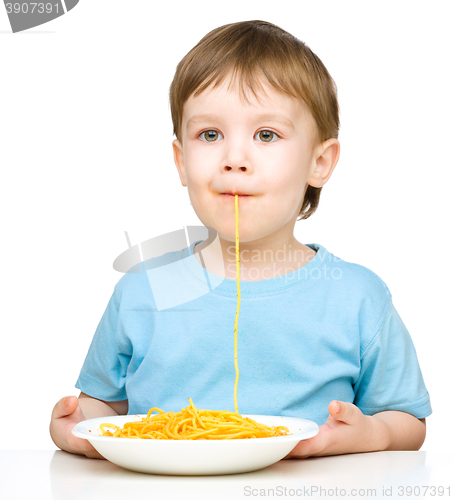 Image of Little boy is eating spaghetti