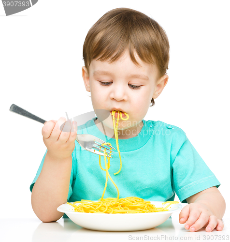 Image of Little boy is eating spaghetti