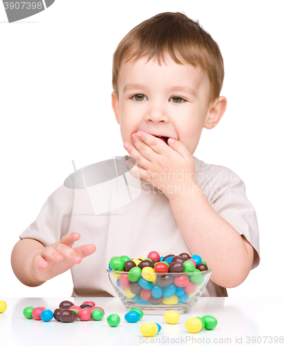 Image of Portrait of a boy with candies