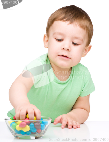 Image of Portrait of a boy with candies