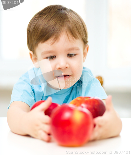 Image of Portrait of a happy little boy with apples