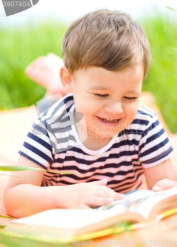 Image of Little boy is reading book