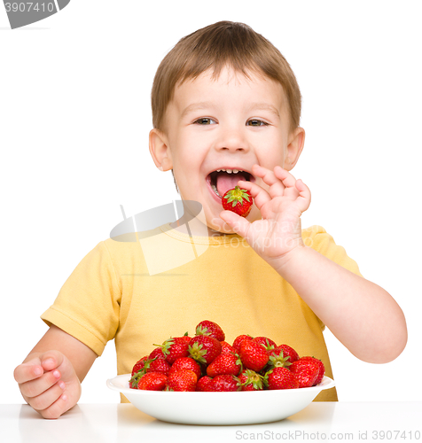 Image of Happy little boy with strawberries