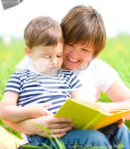 Image of Mother is reading book for her child