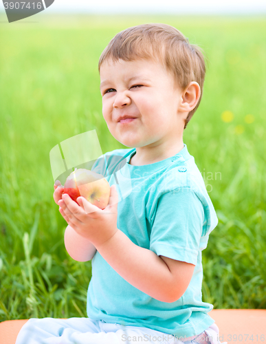 Image of Portrait of a happy little boy with apple