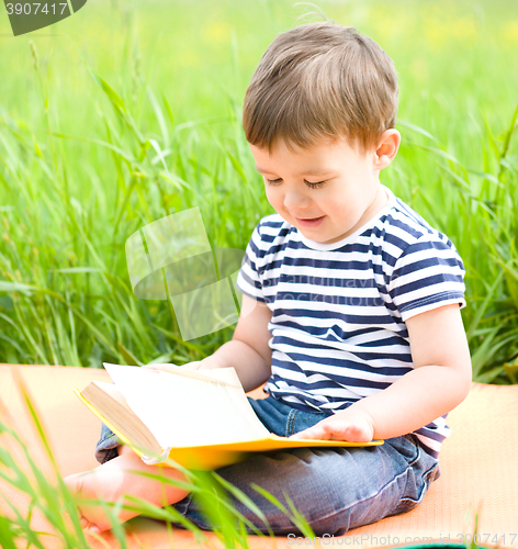 Image of Little boy is reading book