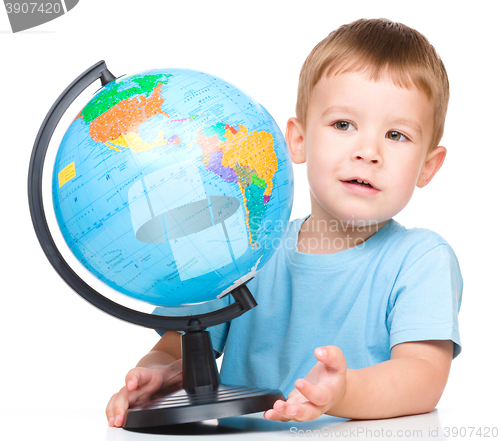 Image of Happy little boy with a globe