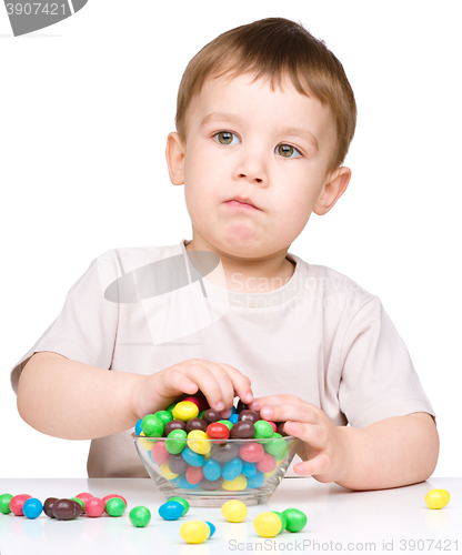 Image of Portrait of a boy with candies
