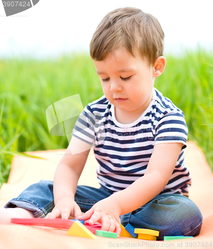Image of Little boy is playing with toys
