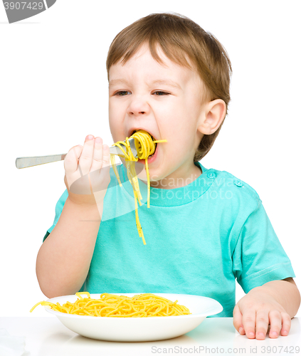 Image of Little boy is eating spaghetti