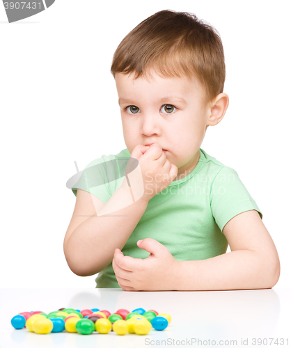 Image of Portrait of a boy with candies