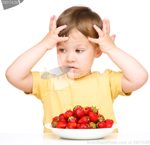 Image of Little boy refuses to eat strawberries