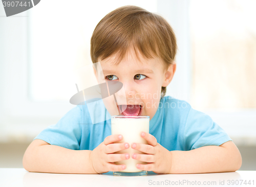 Image of Cute little boy with a glass of milk