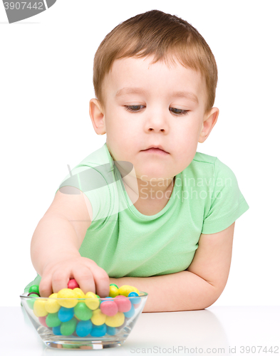 Image of Portrait of a boy with candies