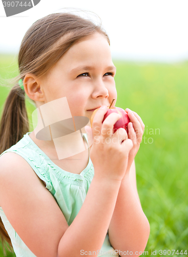 Image of Portrait of a little girl with apple