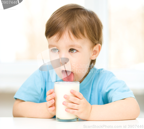 Image of Cute little boy with a glass of milk