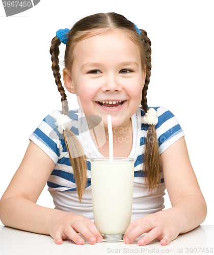 Image of Cute little girl with a glass of milk