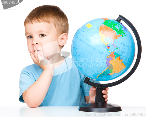 Image of Little boy with a globe