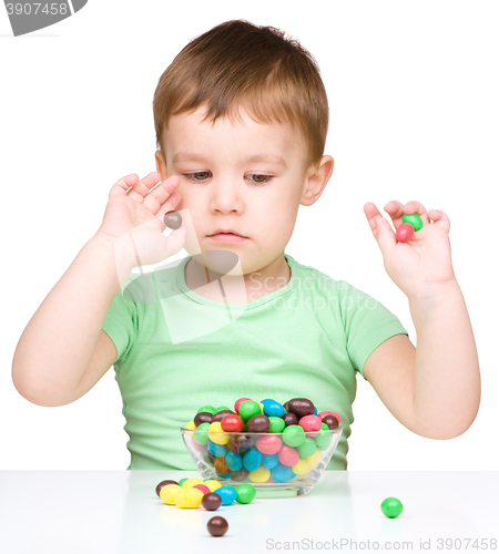 Image of Portrait of a boy with candies