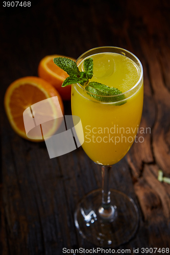 Image of Orange cocktail on rustic wooden table