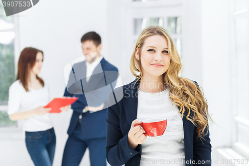 Image of Young colleagues having coffee break in office