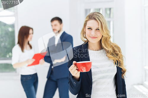 Image of Young colleagues having coffee break in office