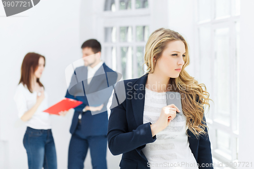 Image of Portrait of businesswoman talking on phone in office