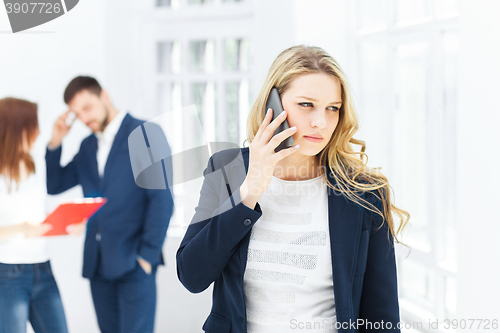 Image of Portrait of businesswoman talking on phone in office