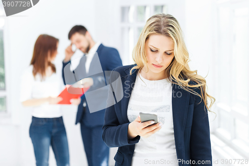 Image of Portrait of businesswoman talking on phone in office