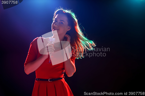 Image of The beautiful girl dancing at the party drinking champagne